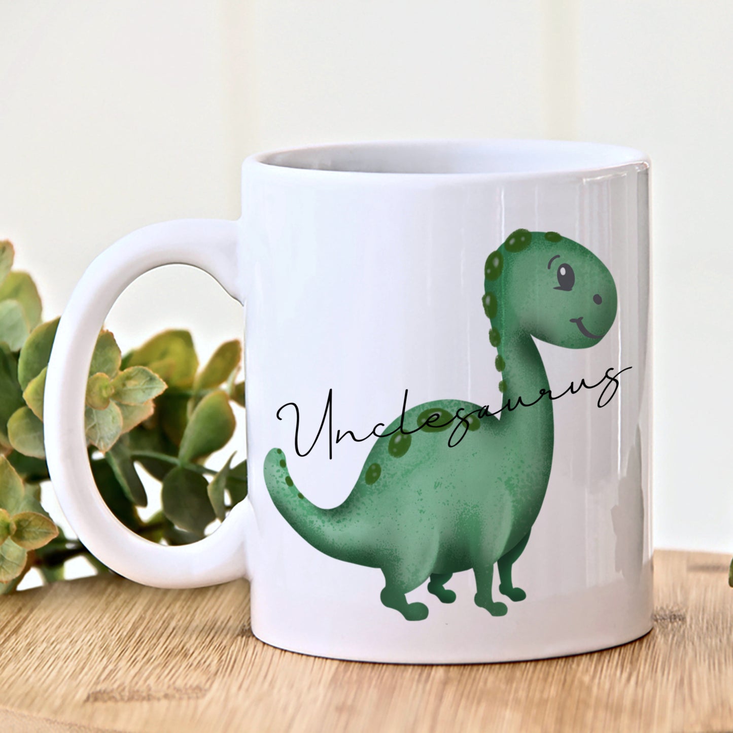 A white ceramic mug with a green dinosaur design and the word 'Unclesaurus' printed on the front.