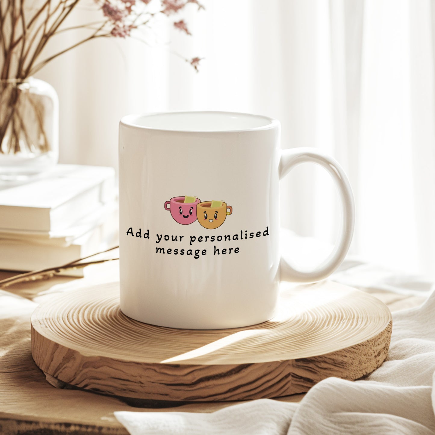White mug with personalized message on a wooden coaster, surrounded by books and a vase.