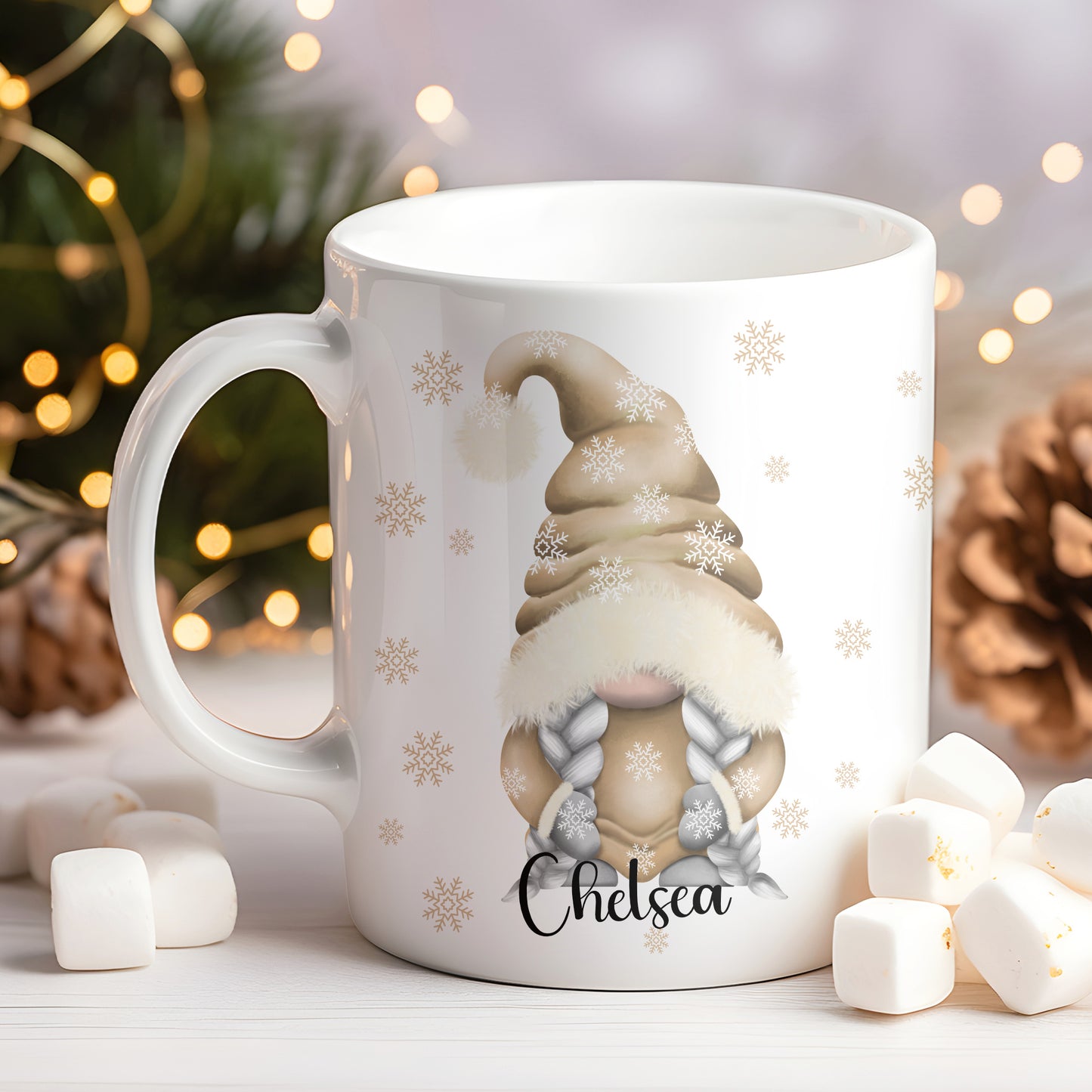 White mug with a gnome design and 'Chelsea' text, surrounded by Christmas decorations.
