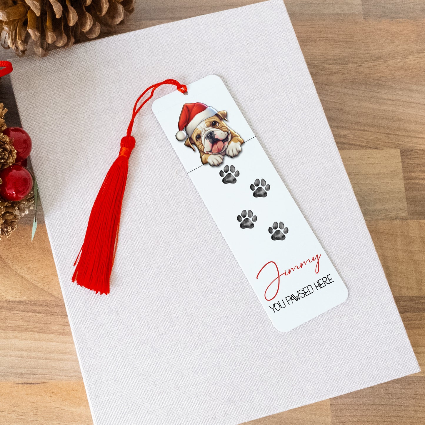 Bookmark with a dog illustration and red tassel on a white surface