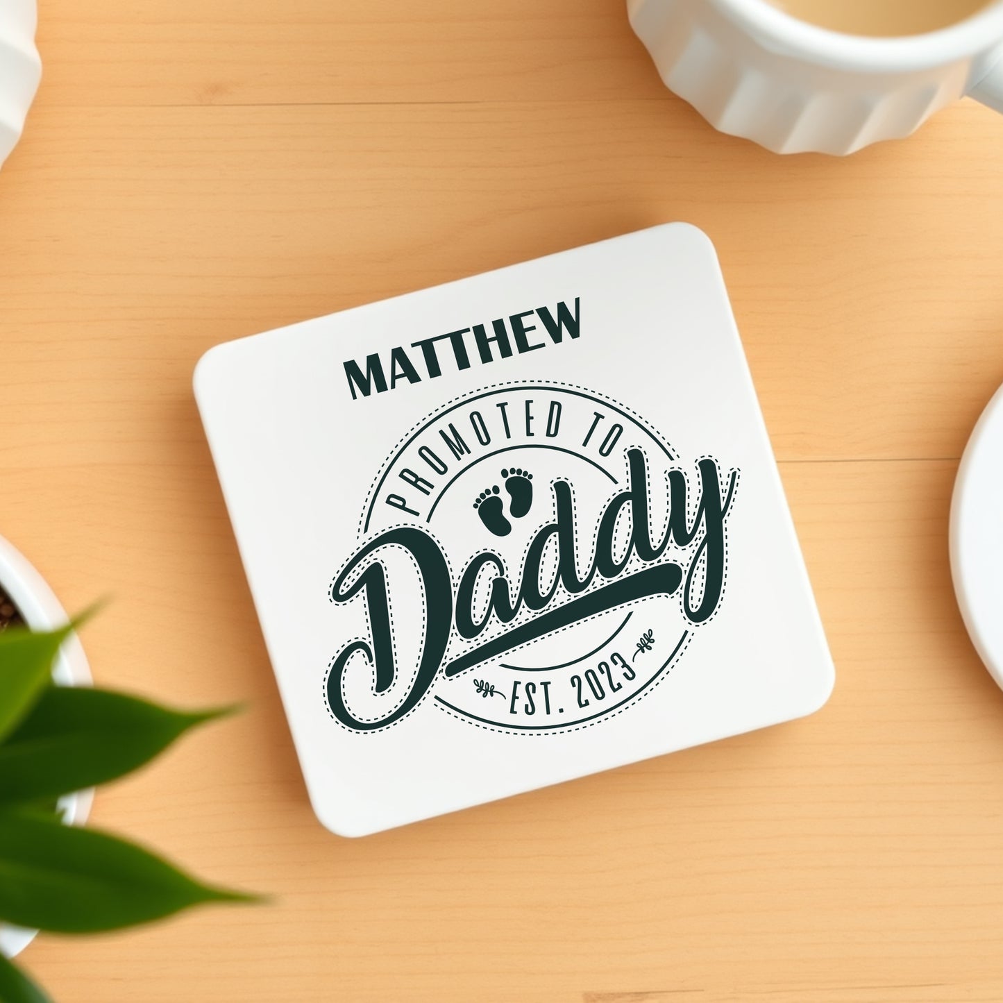 Coaster with 'Promoted to Daddy' text on a wooden surface