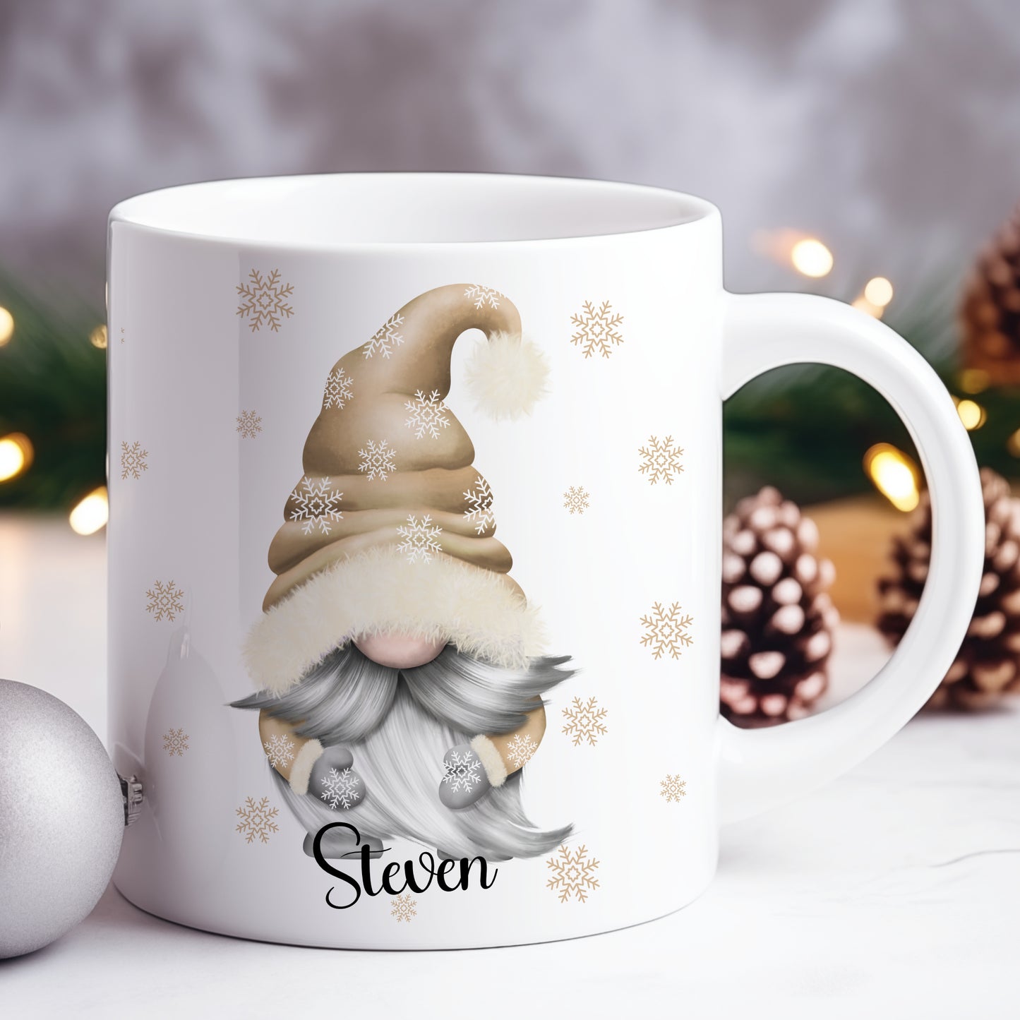 White mug with a Christmas gnome design and 'Steven' text, surrounded by festive decorations.