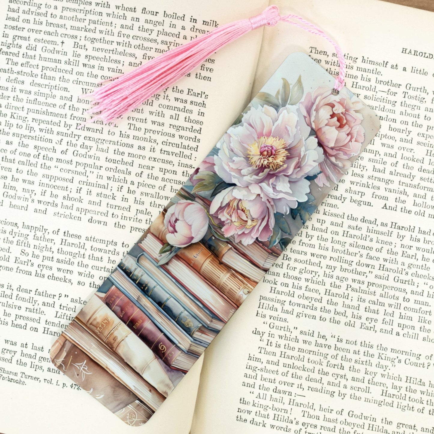Floral bookmark on an open book with a pink tassel
