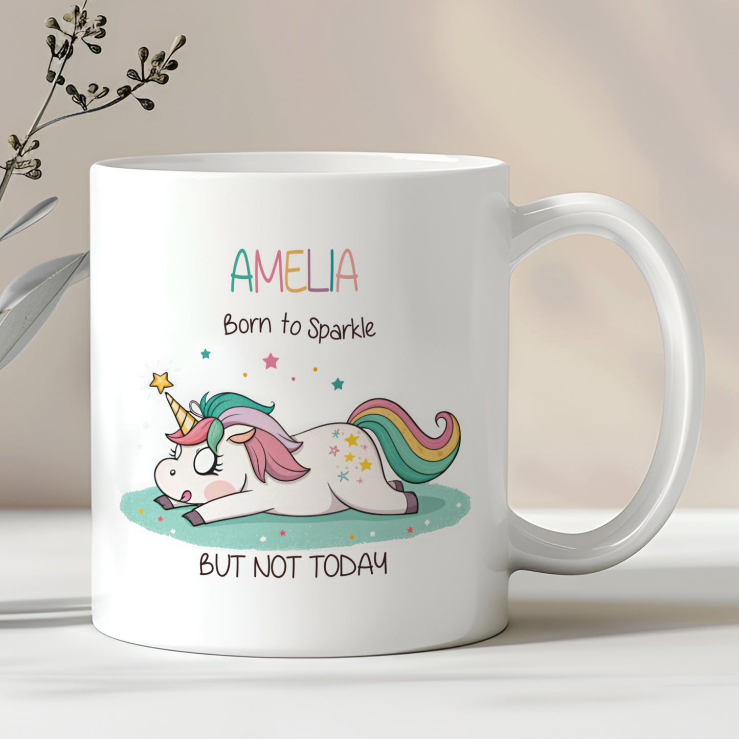 A white ceramic mug with a pastel-coloured unicorn design and the text 'AMELIA Born to Sparkle BUT NOT TODAY' printed on it.