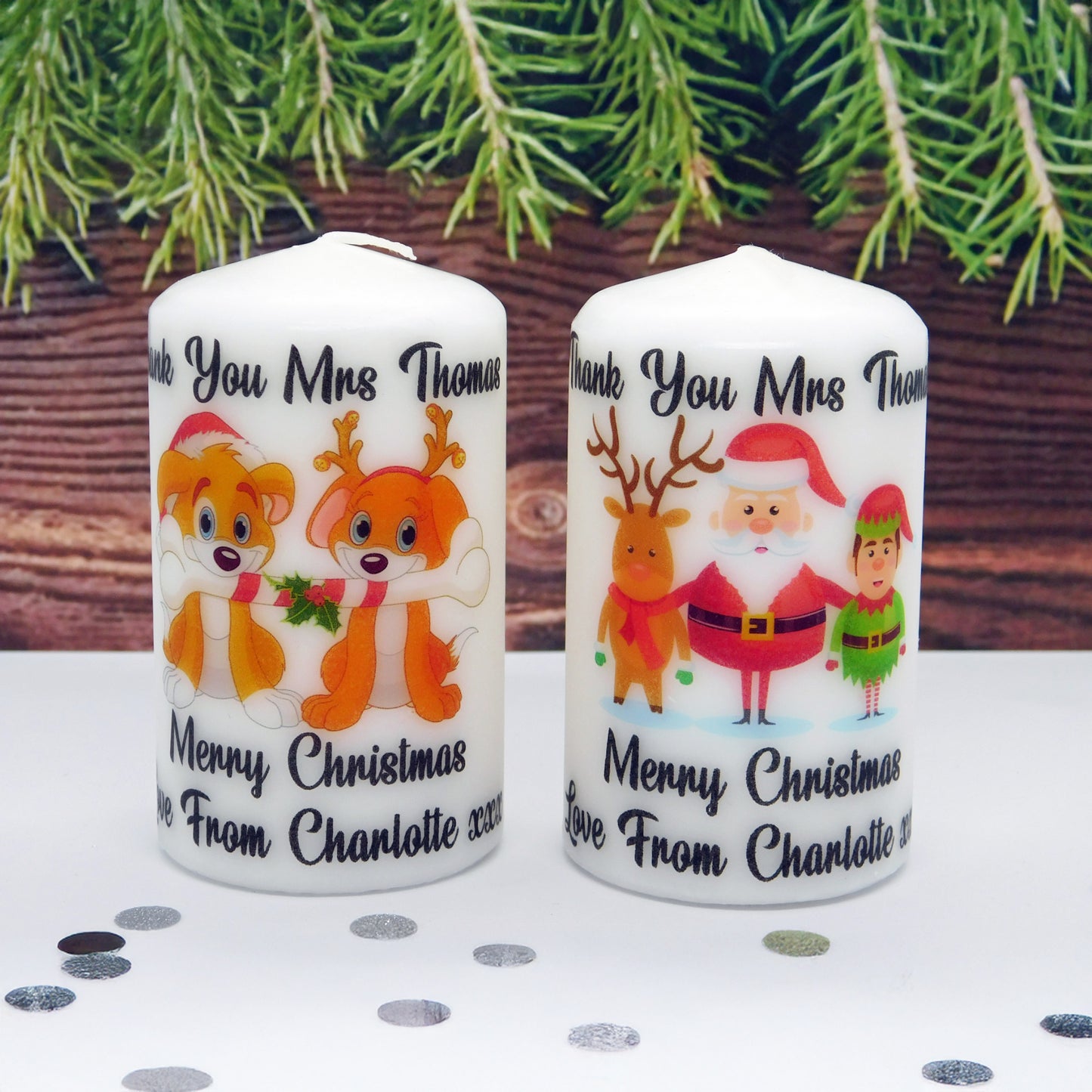Two Christmas-themed candles with personalized text on a polka dot surface.