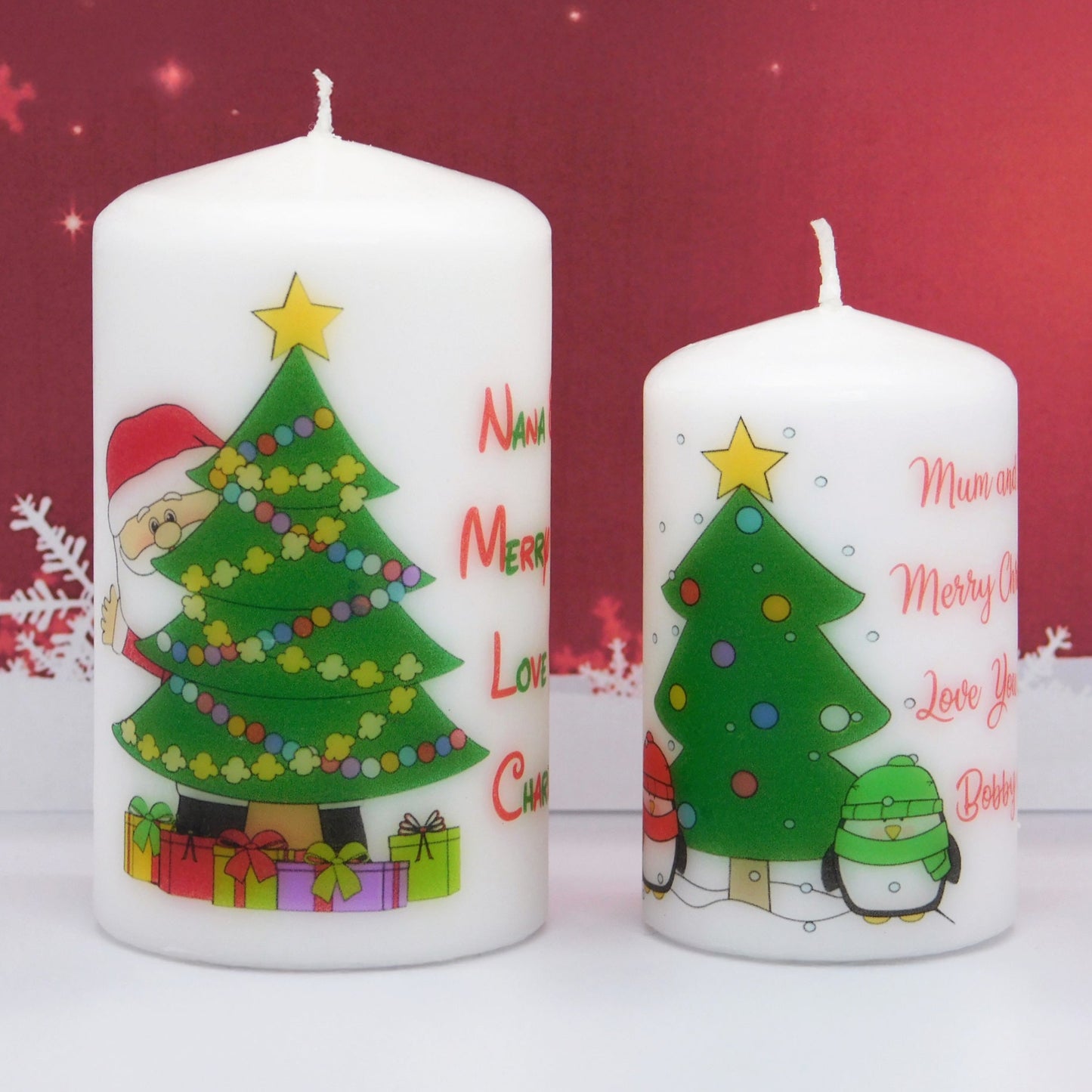 Two Christmas-themed candles with decorative designs on a red background
