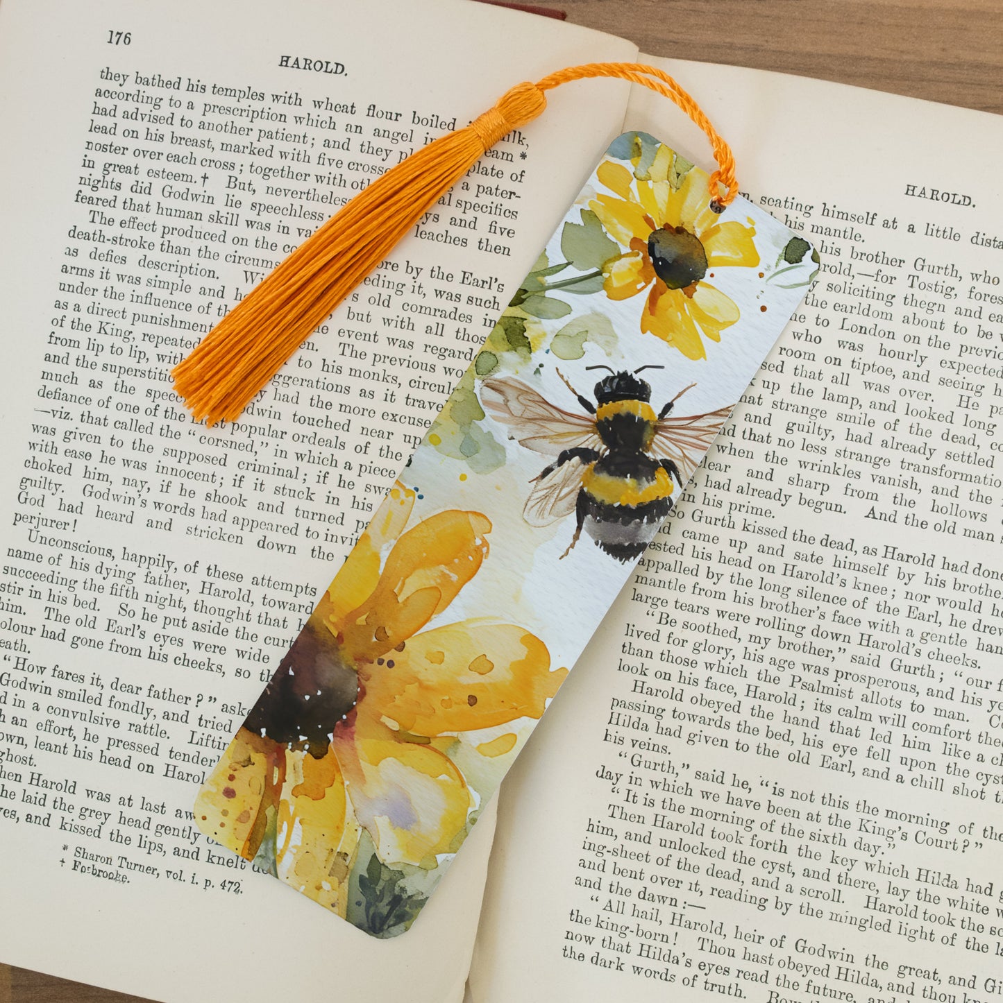 Bookmark with bee and flower design on an open book