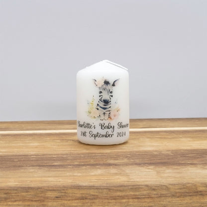 Candle with zebra design and text on a wooden surface