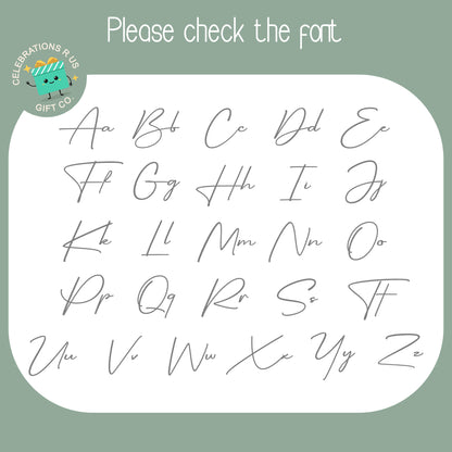 A digital preview sheet showing lowercase cursive alphabet letters from A to Ze in gray script, with the text 'Please check the font' at the top and a circular 'Celebrations Plus Gift Co.' logo in the upper left.