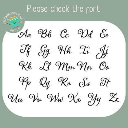 A font preview sheet showing uppercase and lowercase cursive alphabet letters from A to Z on a white rounded rectangle, with a sage green background and the text 'Please check the font' at the top. A circular 'Celebrations R Us Gift Co' logo appears in the upper left.