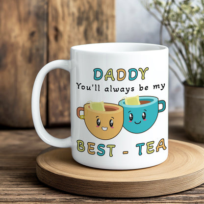 White mug with cartoon tea cups and text on a wooden coaster