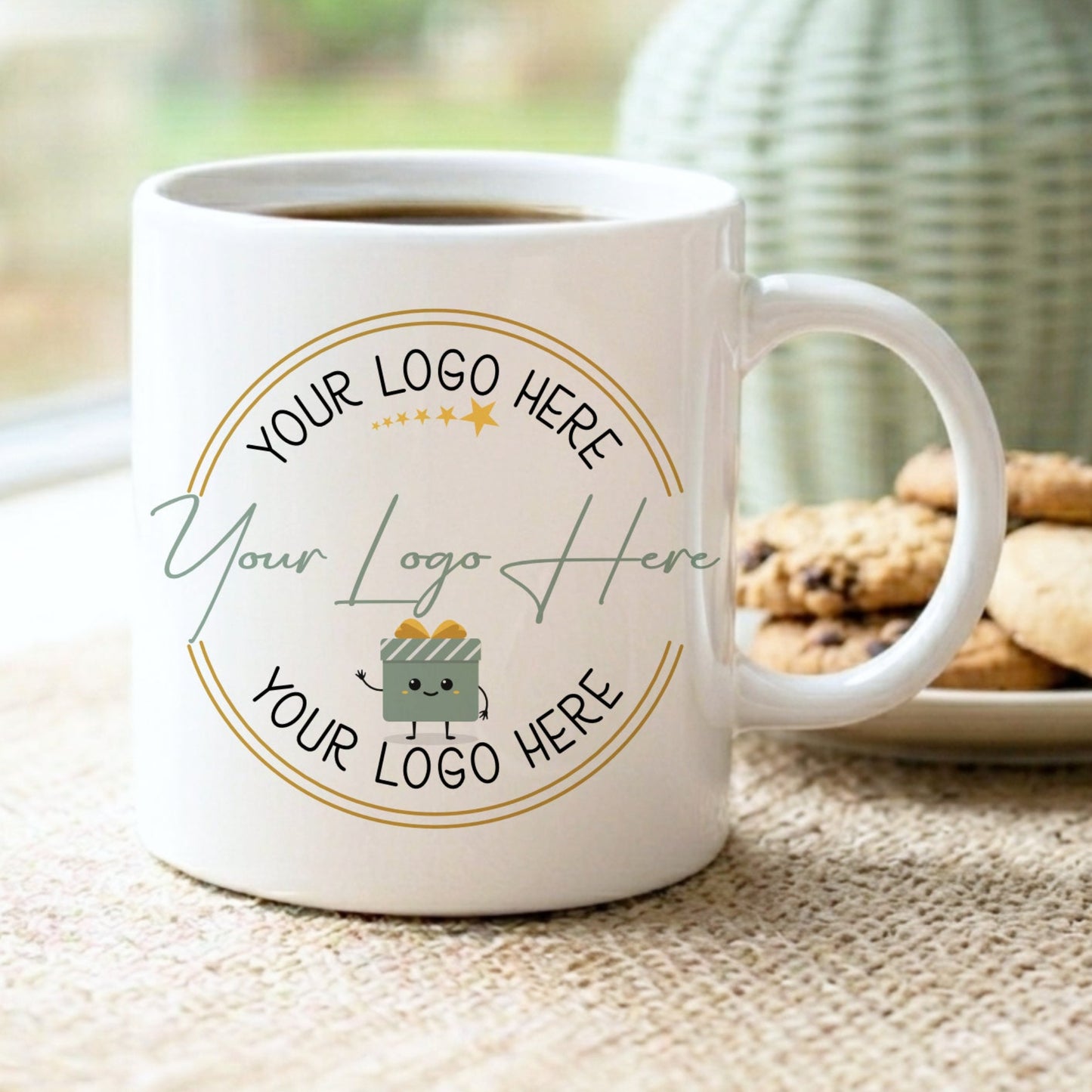 White mug with customizable logo area on a table with cookies and a vase in the background