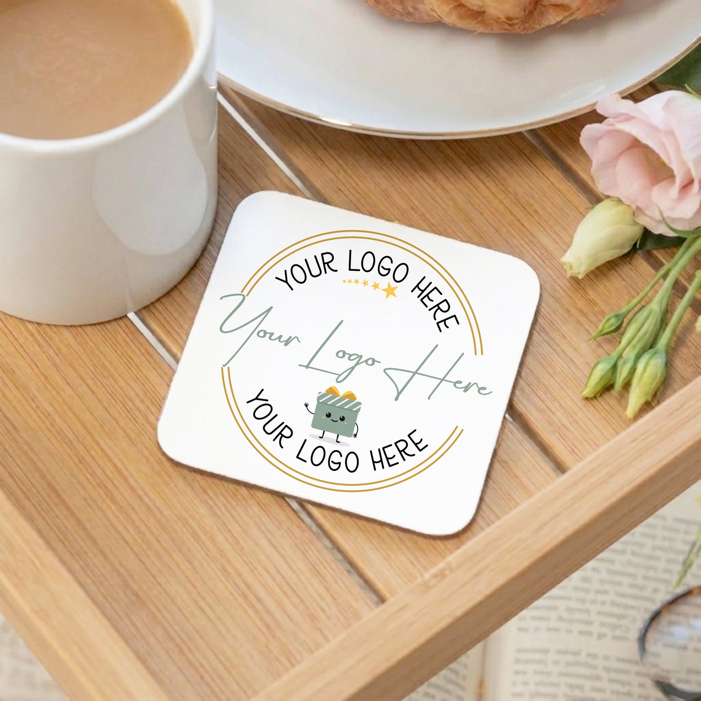 Personalized coaster with customizable text on a wooden table with a cup of coffee and flowers.