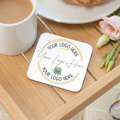 Personalized coaster with customizable text on a wooden table with a cup of coffee and flowers.