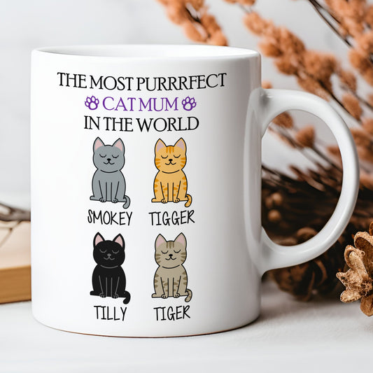 White mug with cat illustrations and text on a white background