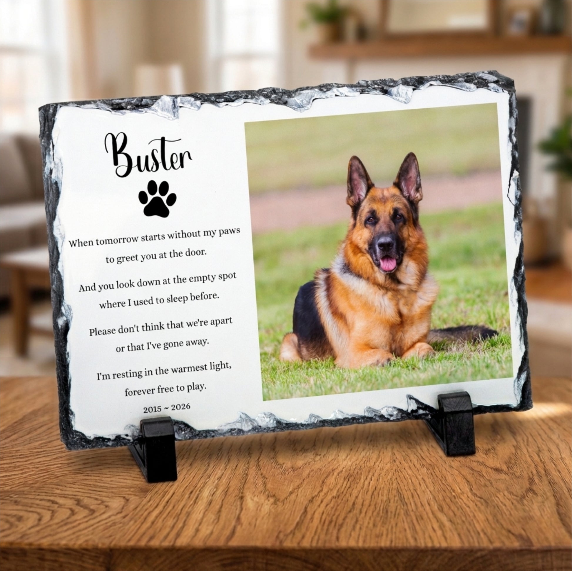 Personalised memorial slate plaque on a wooden table, featuring a photo of a German Shepherd dog and a printed remembrance poem for a dog named Buster.