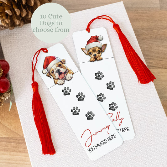 Bookmarks with dog illustrations and red tassels on a wooden surface