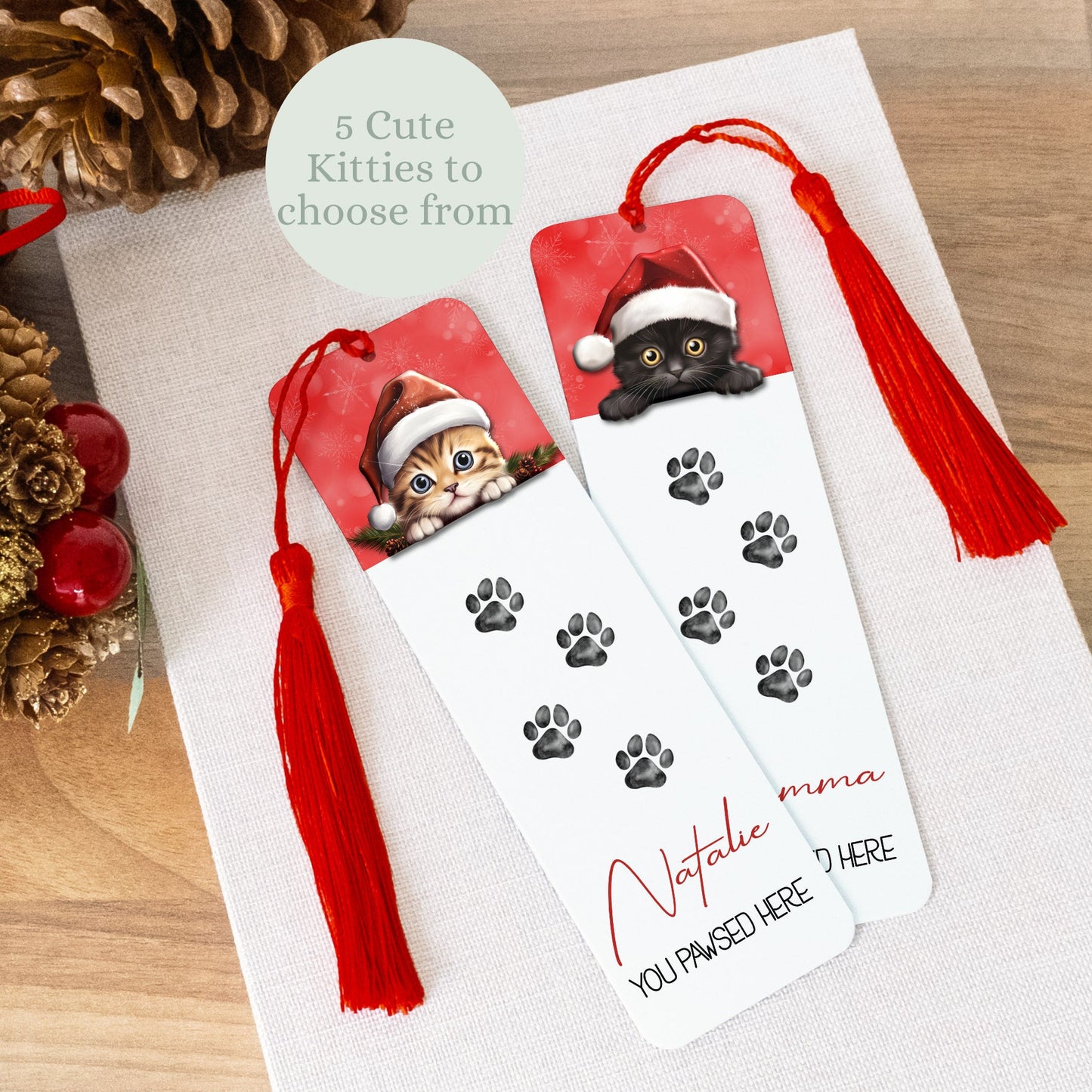Personalized bookmark with cat design and red tassel on a wooden surface