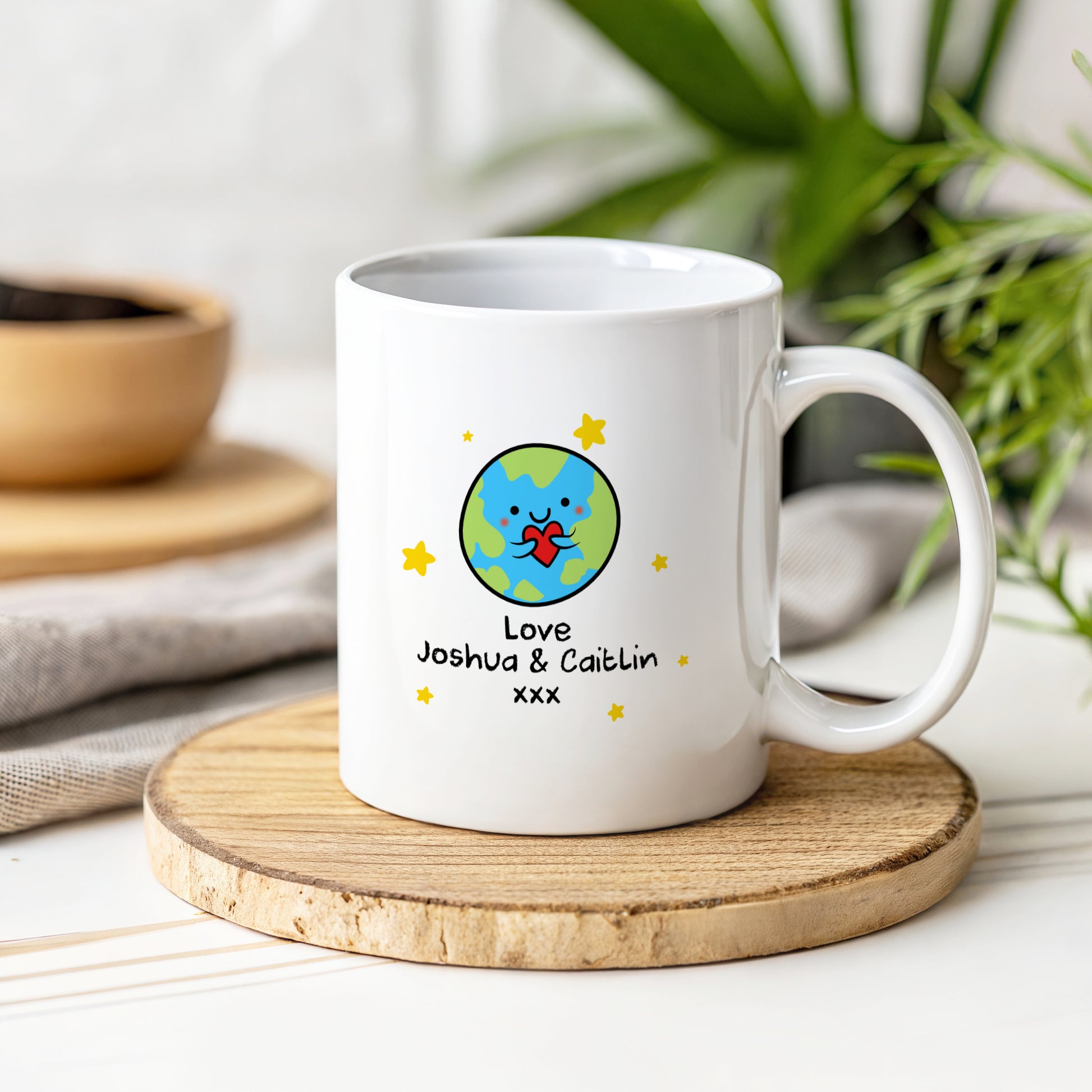 White mug with a colorful地球 design and text on a wooden coaster.