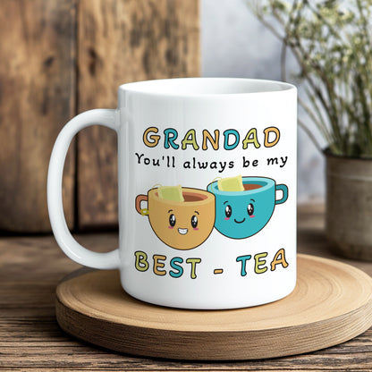 White mug with cartoon tea cups and text on a wooden coaster