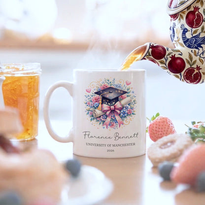 Mug with floral design and text being filled with tea, surrounded by food items.