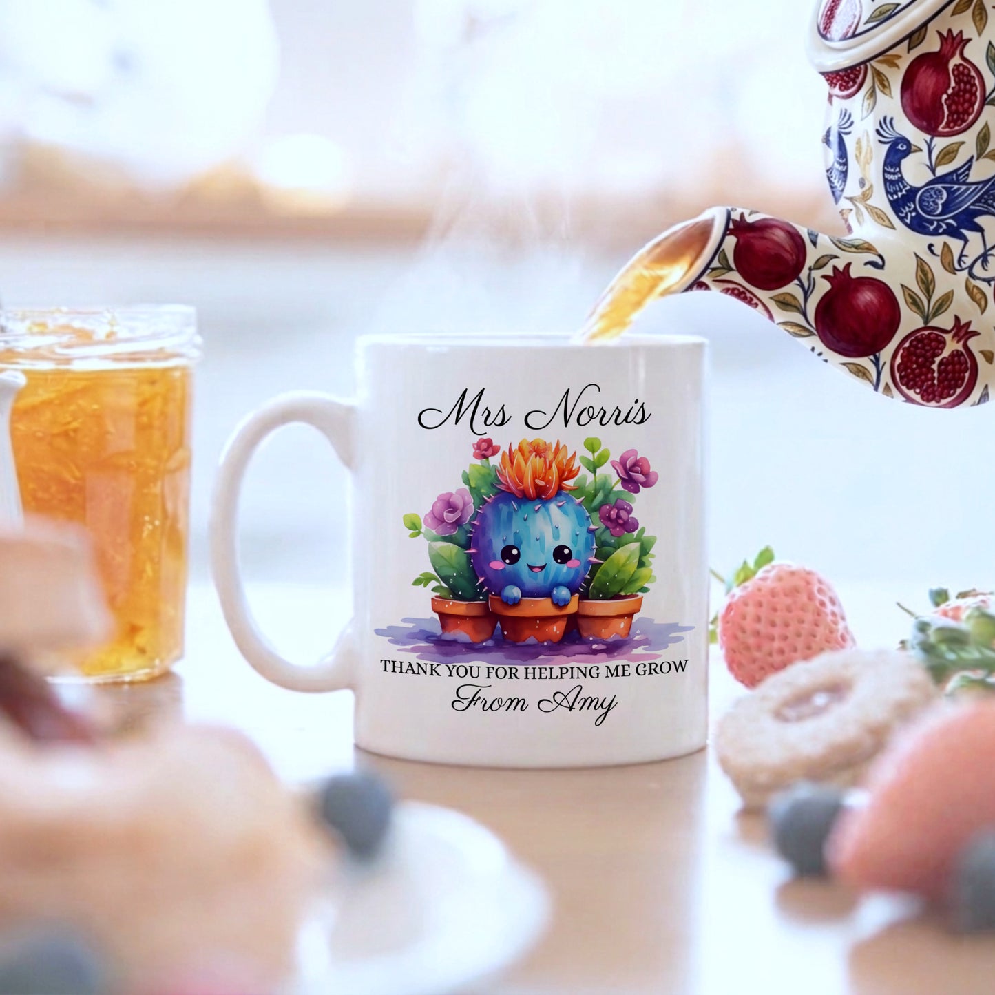 White ceramic personalised teacher gift mug featuring a smiling watercolour cactus with colourful flowers, personalised with teacher name 'Mrs Norris' and message 'Thank You For Helping Me Grow From Amy', with tea being poured from a floral teapot