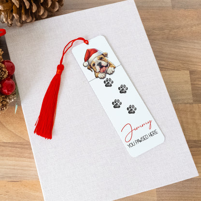 Bookmark with a dog illustration and red tassel on a white surface