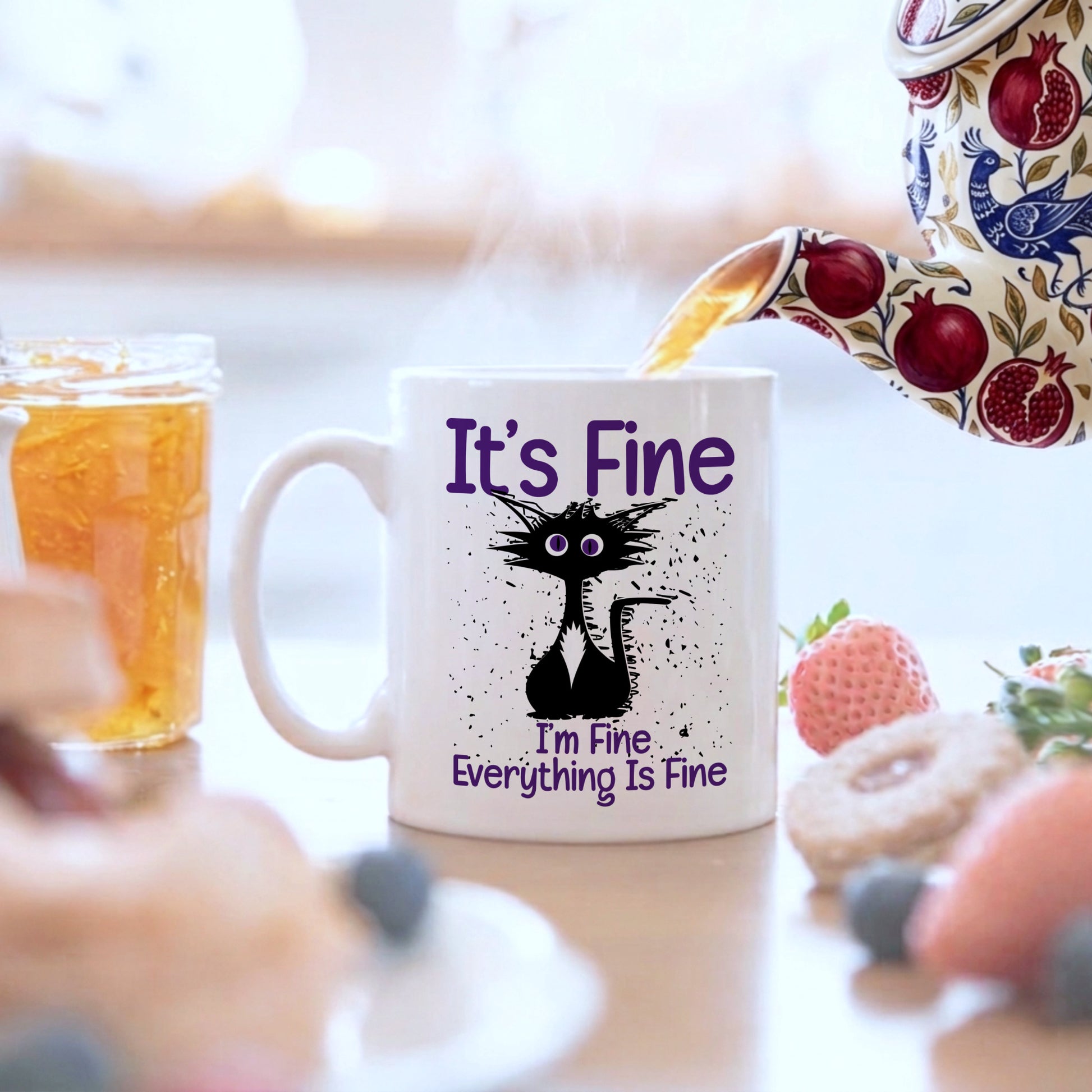 Mug with a cat illustration and text 'It's Fine, I'm Fine, Everything is Fine' being filled with tea.