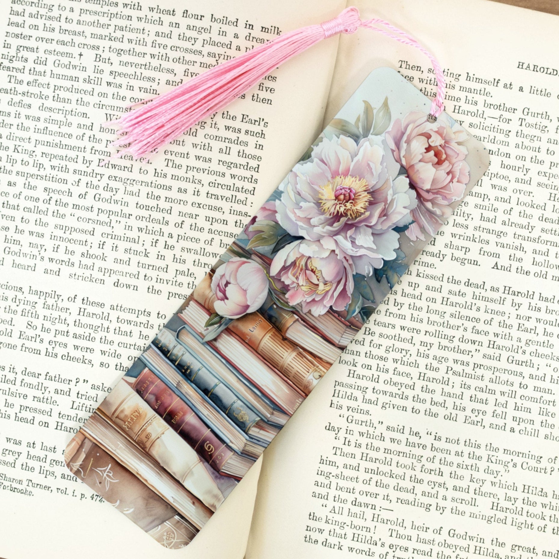 Floral bookmark on an open book with a pink tassel