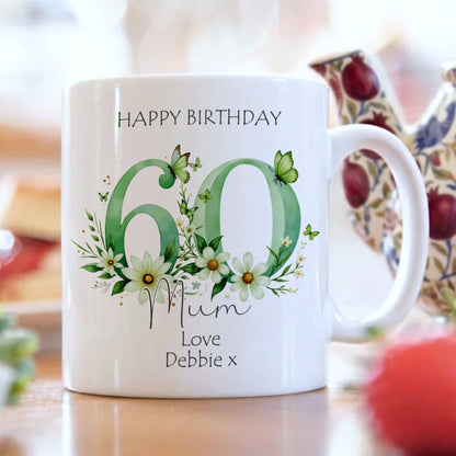 White mug with floral design and text on a blurred background