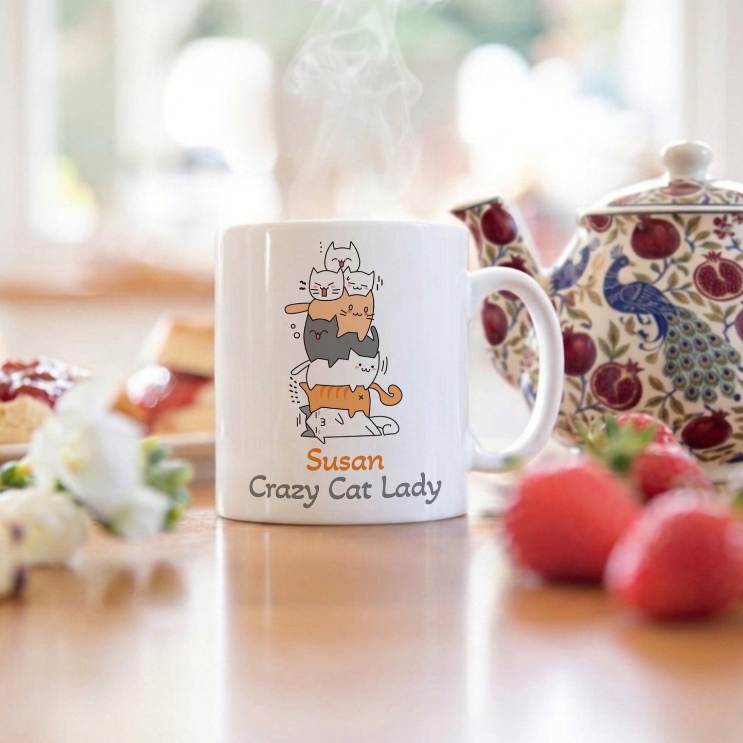 Mug with 'Susan Crazy Cat Lady' design on a table with a teapot and fruit in the background