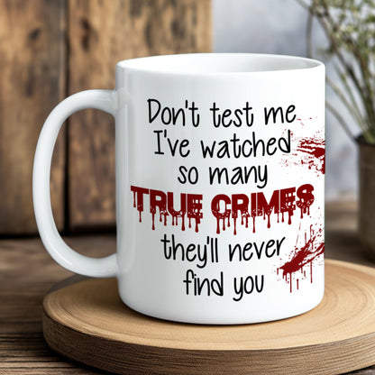 White mug with text and blood-like design on a wooden coaster
