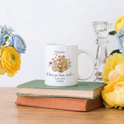 Personalized mug with teddy bear design on books with flowers and a candle holder.