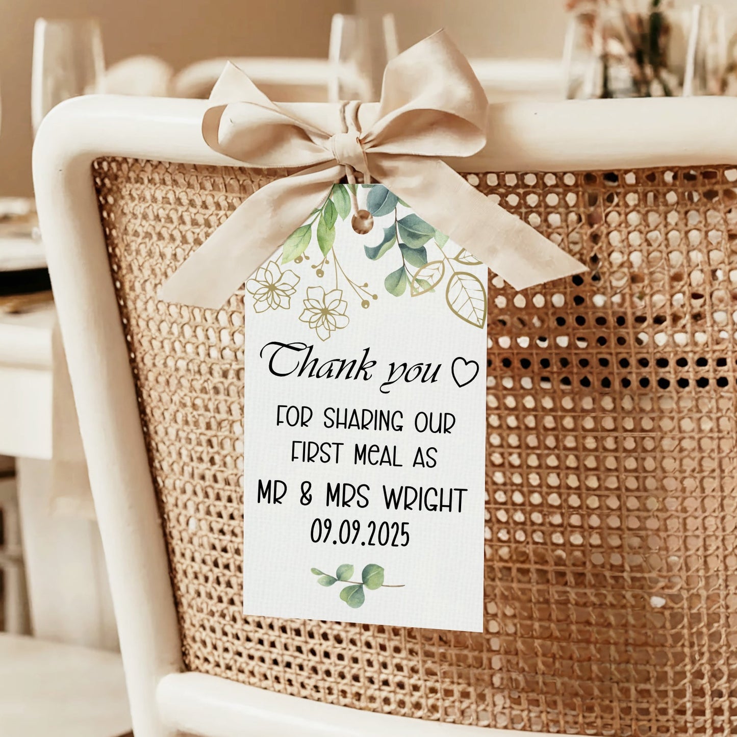 Chair with a decorative bow and personalized tag on a dining table setting.