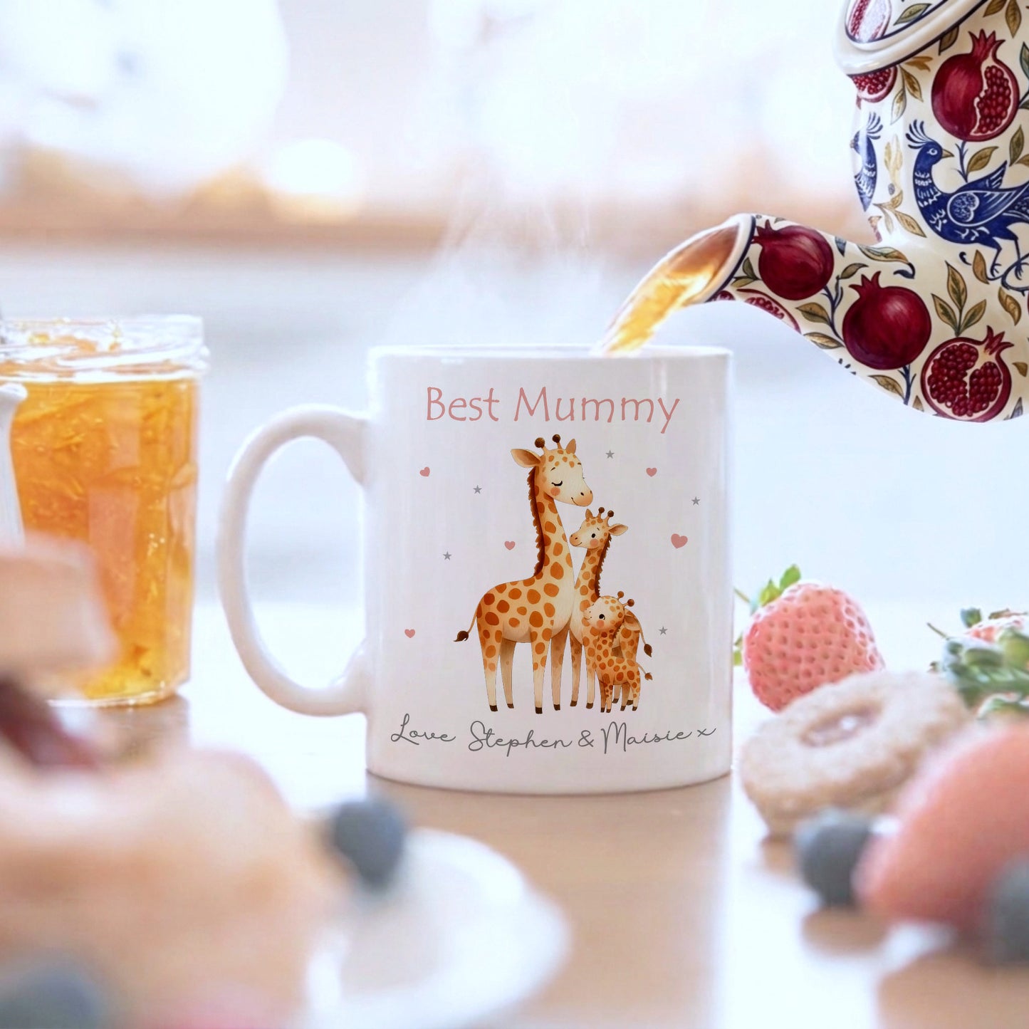 White mug with giraffe design and 'Best Mummy' text, being filled with tea.