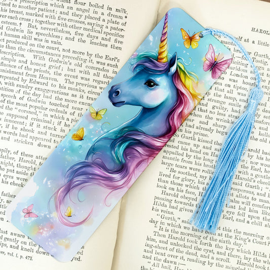 Colorful unicorn bookmark with butterflies on an open book