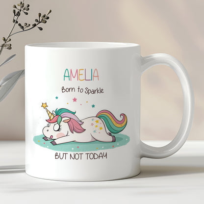 A white ceramic mug with a pastel-coloured unicorn design and the text 'AMELIA Born to Sparkle BUT NOT TODAY' printed on it.