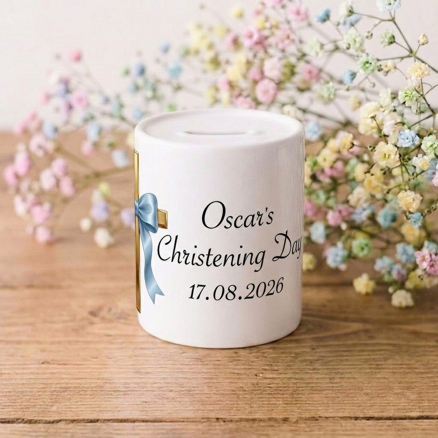 A white ceramic baby christening money box with custom text reading 'Oscar's Christening Day 17.08.