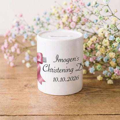 A white ceramic christening money box with custom black text reading 'Imogen's Christening D 10.01.