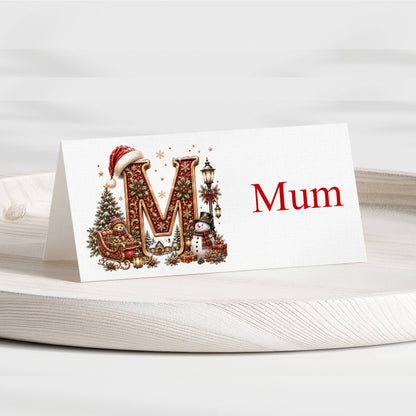 Personalised Christmas alphabet place card with illustrated M initial and name Mum on Christmas table setting
