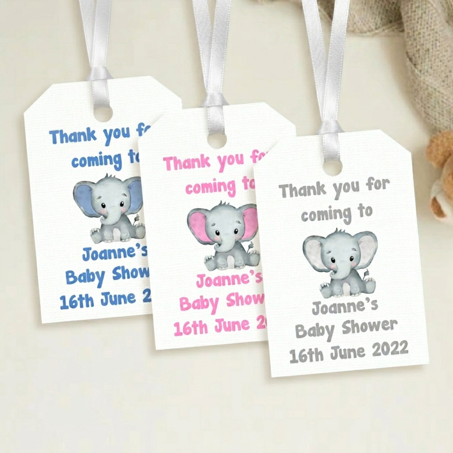 Three baby shower favour tags with elephant illustrations and personalised text.