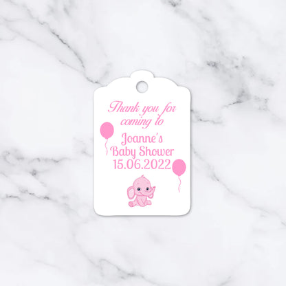 A white paper gift tag with scalloped edges, featuring pink text that reads 'Thank you for coming to Joanne's Baby Shower 15.06.