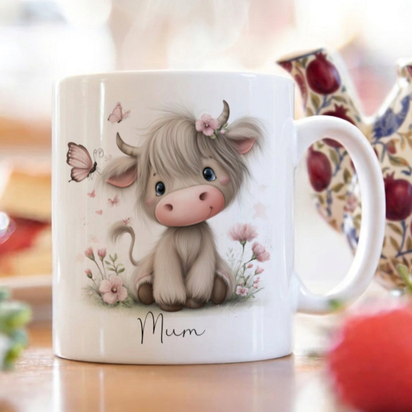 Mug with a cute cow illustration and 'Mum' text on a blurred background