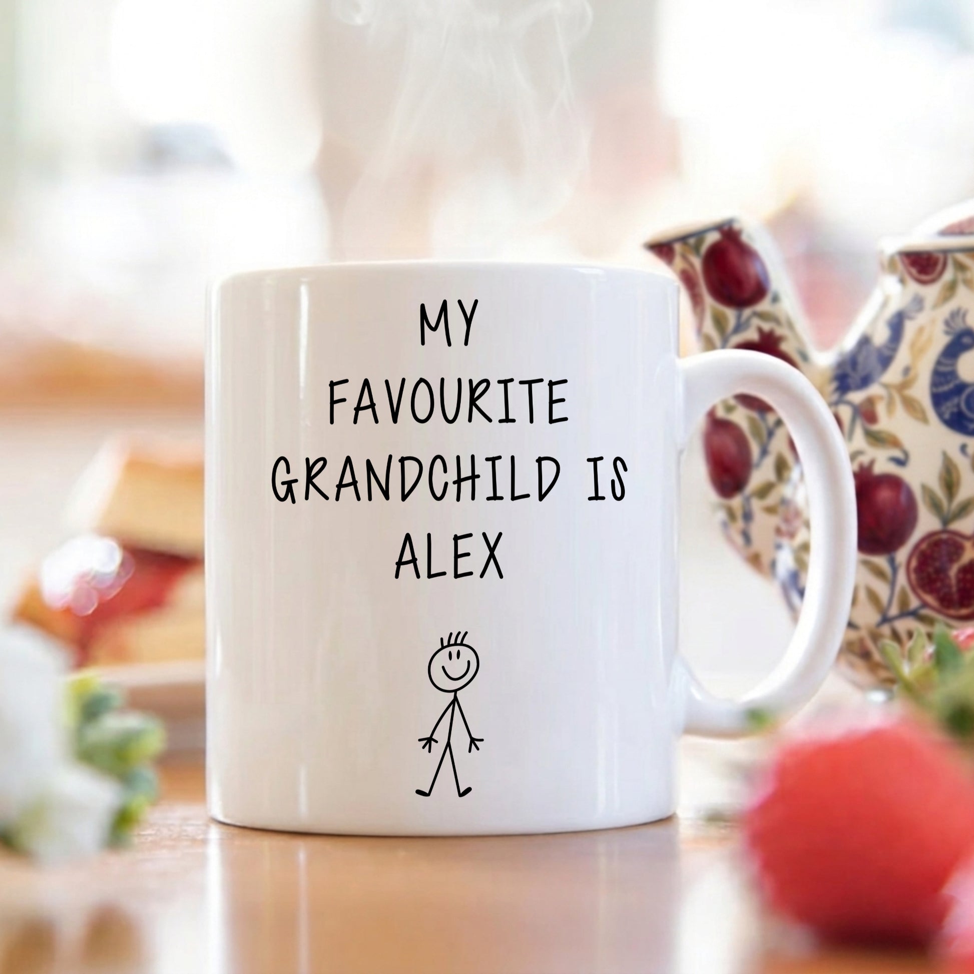 White mug with 'My Favourite Grandchild is Alex' text on a blurred background