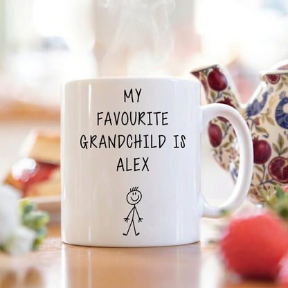 White mug with 'My Favourite Grandchild is Alex' text on a blurred background
