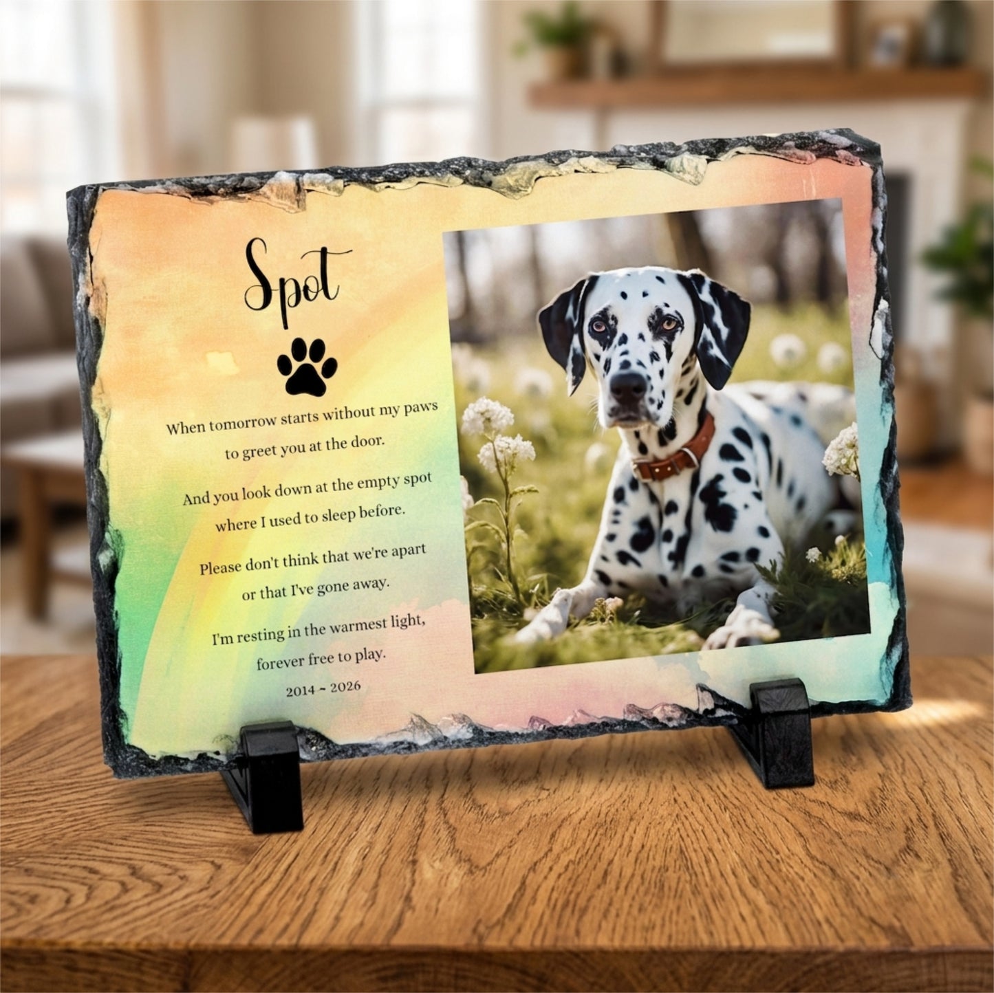 Personalised memorial slate plaque on a wooden table, featuring a photo of a Dalmatian dog and a poem titled 'Spot' with a black paw print.