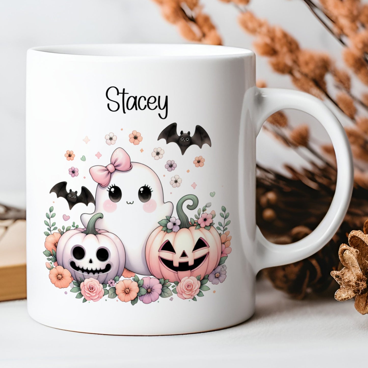 White mug with Halloween-themed design featuring pumpkins, ghosts, and flowers on a neutral background.