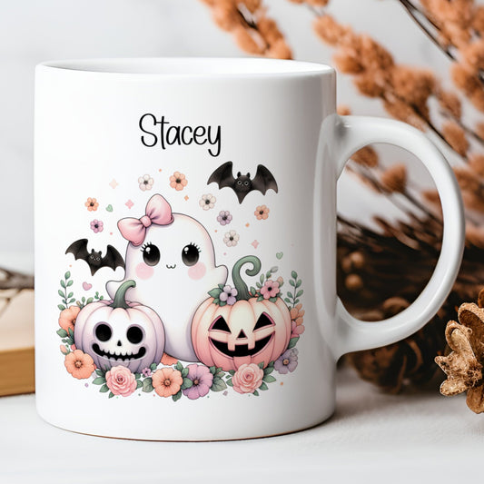 White mug with Halloween-themed design featuring pumpkins, ghosts, and flowers on a neutral background.