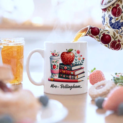 Tea being poured in to Personalised teacher mug with colourful stacked books and red apple design, customised with a teacher's name