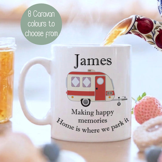 A white ceramic mug with a personalised name 'James' and a red caravan illustration, shown in a breakfast setting with a teapot pouring tea, a glass of iced tea, and fruit on a table. A green circular badge reads '8 Caravan colours to choose from'.